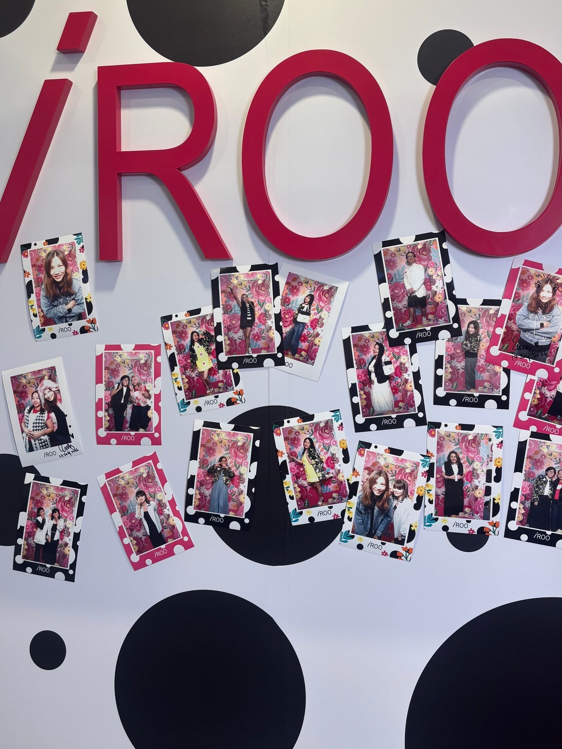 The Playhouse wall, where guests pinned and signed their prints beneath the iROO letters